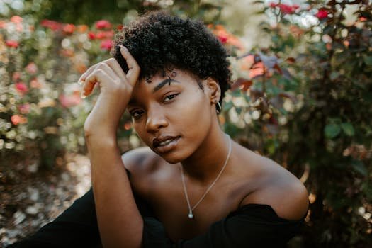 pexels-photo-5091121-5091121 Close-up portrait of a woman surrounded by vibrant foliage, showcasing natural beauty.